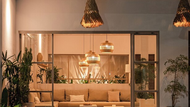 A modern living room with a sofa, coffee table, and potted plants. - A.K.A House Of Yin & Yang Canggu (Canggu)