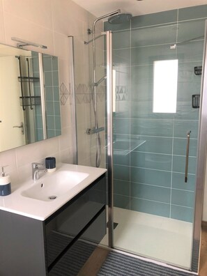 Een douche, een haardroger, handdoeken, toiletpapier