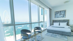 A modern hotel room with a large window overlooking a body of water and a bridge. - HAPPY SEASON I Al Bateen Residences  (Dubai)