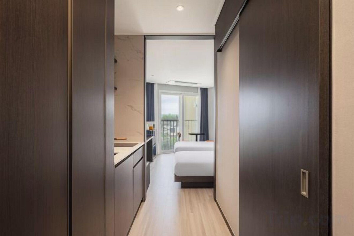 Premium bedding, desk, laptop workspace, blackout drapes