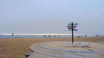 A beach with a signpost and the word "SOKCHO" on the ground.