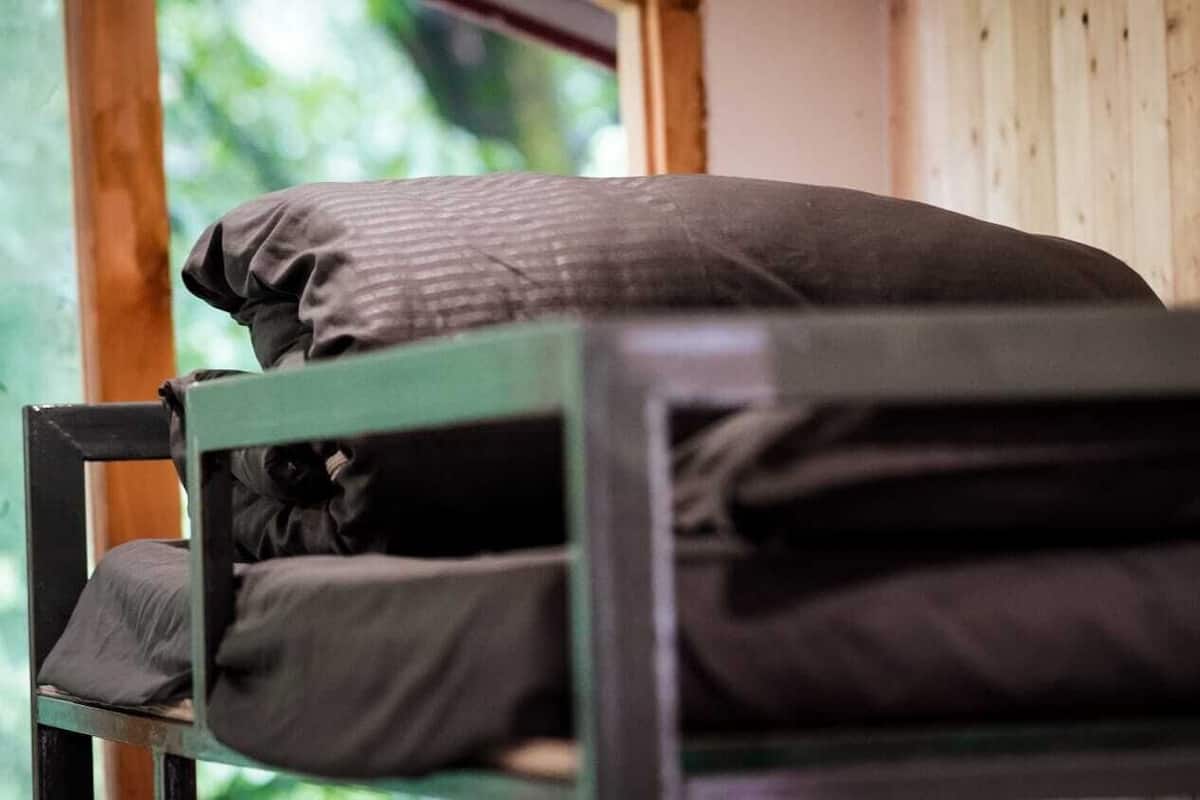 A bunk bed with a pillow and a blanket.