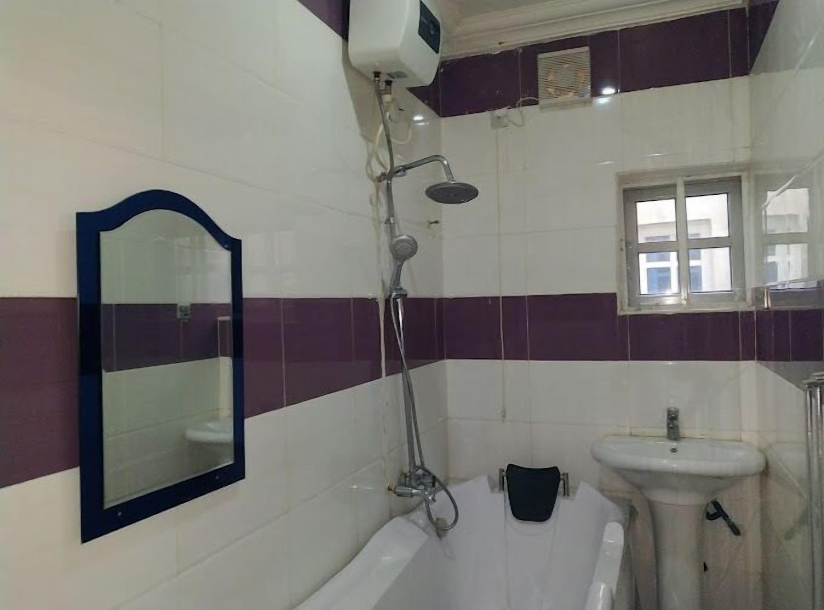 A bathroom with a bathtub, a sink, and a shower.