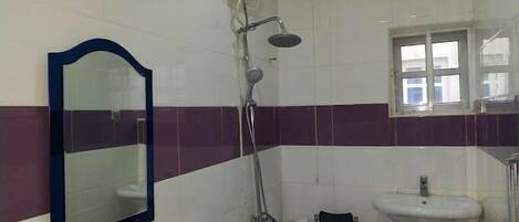 A bathroom with a bathtub, a sink, and a shower.
