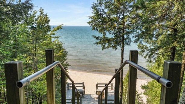 A wooden staircase leading to a beach with a view of the sea. - Lakeside Home with Panoramic Views of Lake Michigan! (Harbor Springs)