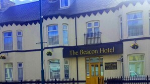 The Beacon Hotel with a prominent entrance, a balcony, and a sign indicating it is a hotel. - The Beacon Hotel (Redcar)