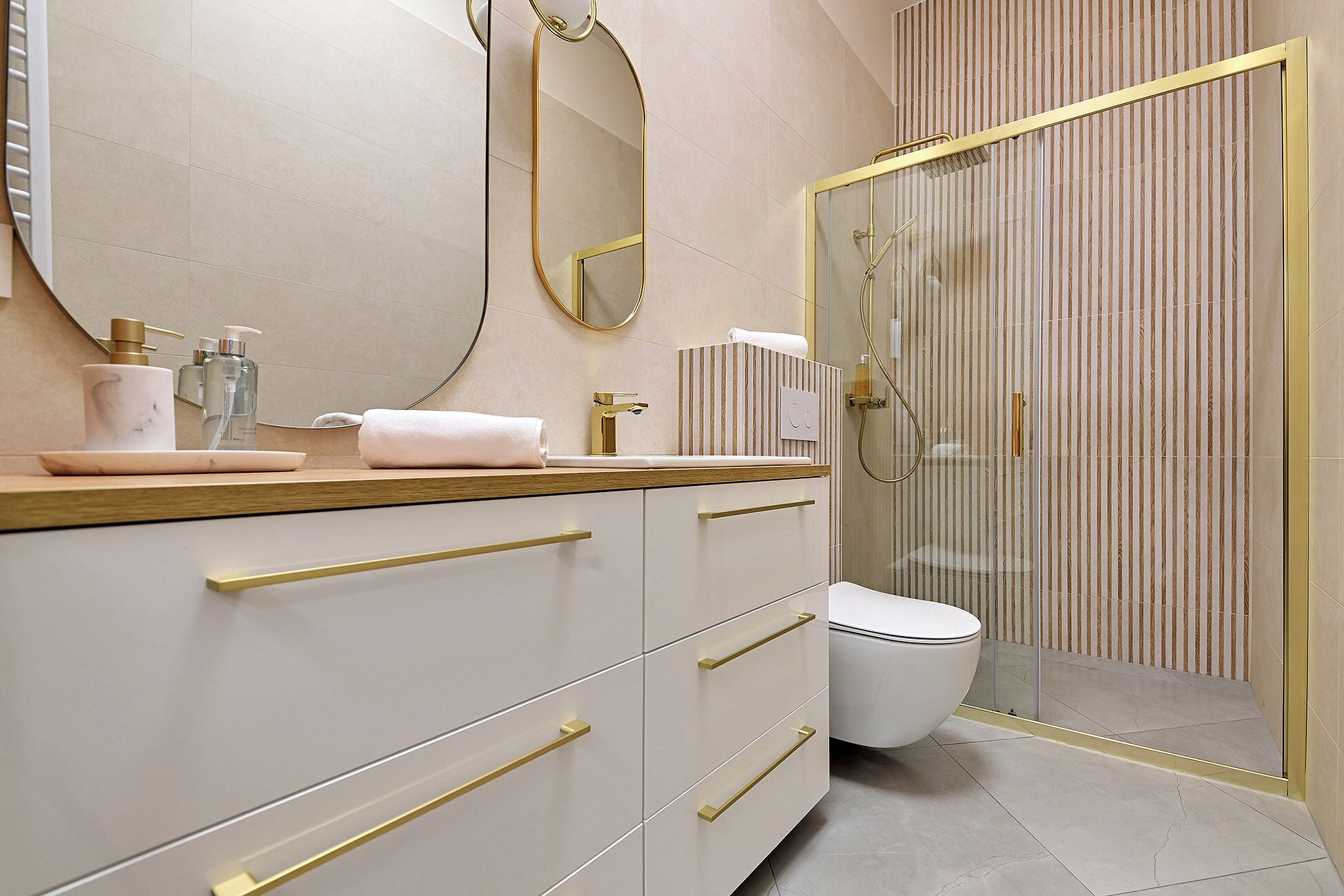 A modern bathroom with a vanity, a toilet, and a shower area.