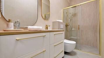 A modern bathroom with a vanity, a toilet, and a shower area.