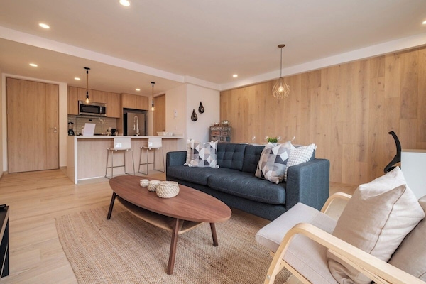 Open living and kitchen with a sofa and coffee table, a social heart for the home near Parque Mexico