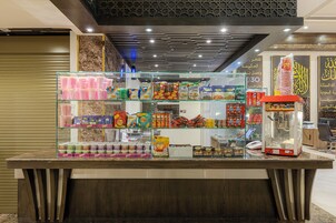 A snack kiosk with various packaged goods and a popcorn machine.