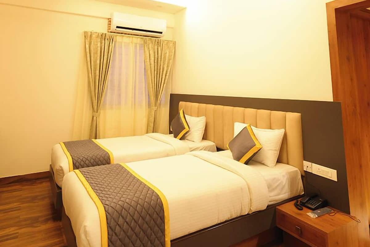 A hotel room with a bed, bedside table, and a ceiling fan.