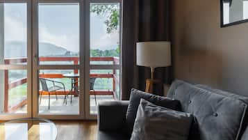 Apartment, Balcony, Mountain View | Living room | Flat-screen TV