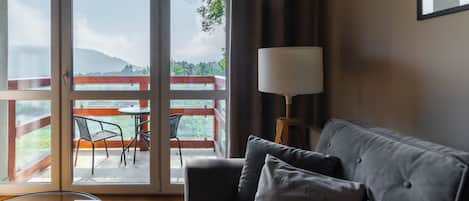 Apartment, Balcony, Mountain View | Living room | Flat-screen TV