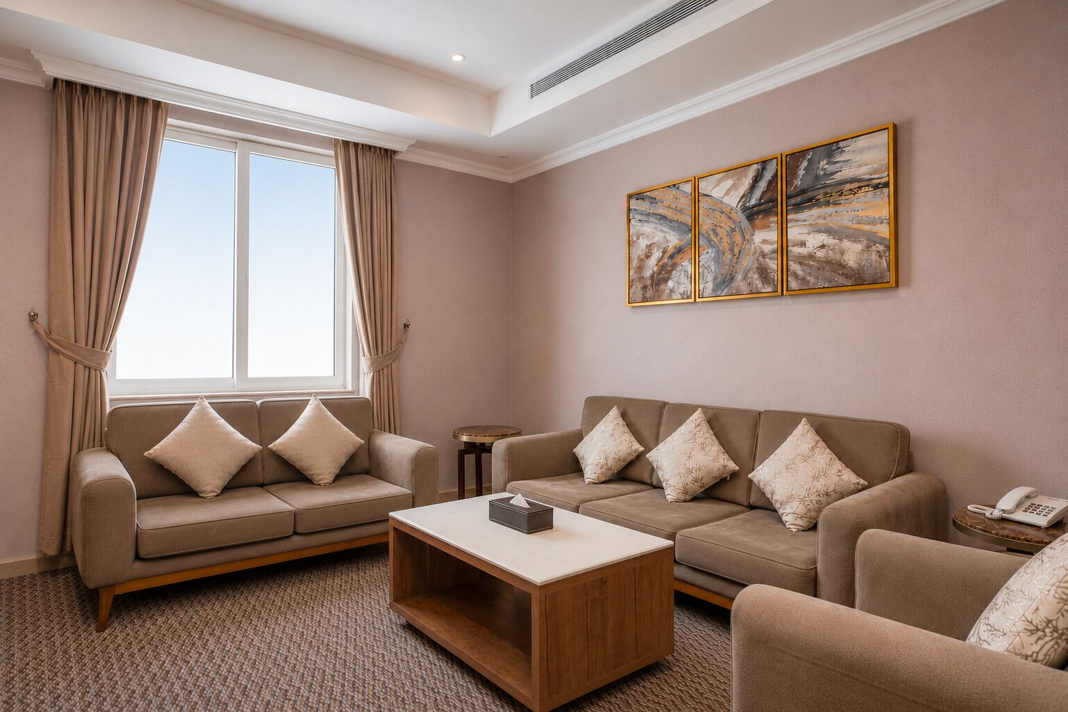 A living room with two sofas, a coffee table, and a painting on the wall.