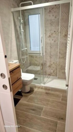Shower, towels, toilet paper