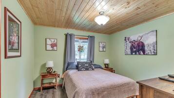 Cozy retreat with a bed, bedside tables, and artwork adorns the walls.