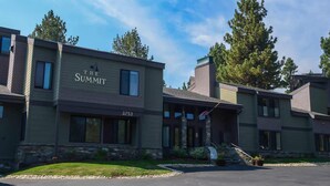 A multi-story building with the sign "The Summit" and the address "3253".