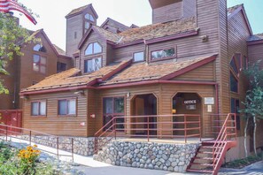 A wooden building with a stone foundation, a red staircase, and an 'Office' sign. - Aspen Creek #204 | Near Golf, Fishing & Hiking (Mammoth Lakes)
