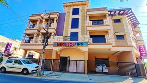 A multi-story building with a sign reading "NEIGHBOUR INN" indicating it is a lodging establishment. - Neighbour Inn Elite (Chennai)