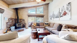 A cozy living room with a fireplace, a sofa set, and a coffee table.