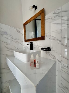 Chuveiro, sabonete, shampoo, papel higiênico