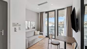 One-Bedroom Suite with Balcony | Living area | 50-inch flat-screen TV with cable channels