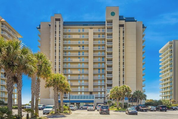 Experience the modern hotel's elegant design, featuring a central entrance and balconies on each floor.