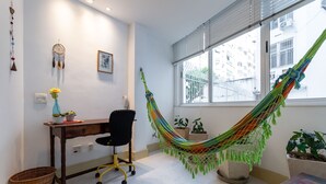 A room with a desk, chair, hammock, and potted plants. - 4 Minutes From Copacabana Beach Nsc205 (Rio de Janeiro)