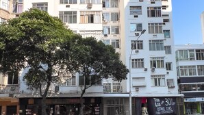 A multi-story building with a modern architectural design, featuring balconies and large windows. - 4 Minutes From Copacabana Beach Nsc205 (Rio de Janeiro)