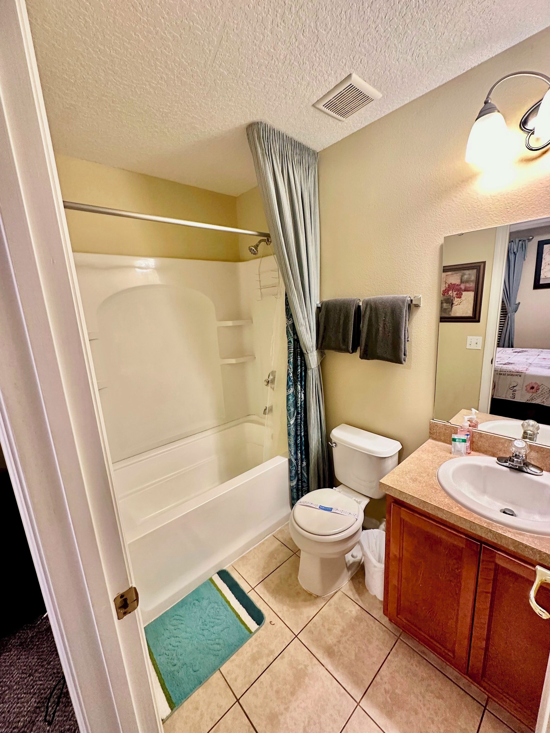 A bathroom with a bathtub, toilet, and sink.