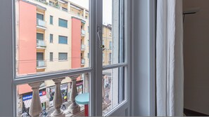 A window with a view of a building with balconies and a street below. - Italianway - Padova 37 (Milan)