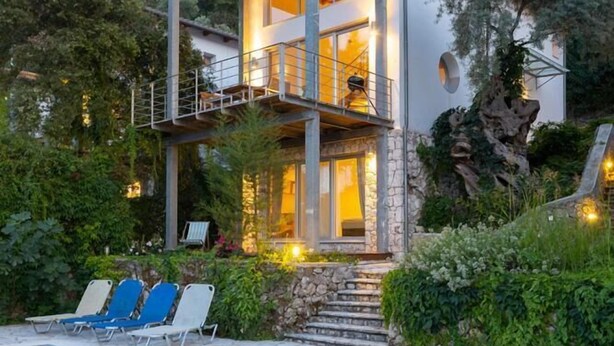 A modern two-story house with a pool, surrounded by lush greenery and a mountainous backdrop. - Villa Milos - Three Bedroom Villa, Sleeps 6 (Lefkada)