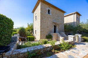 A stone building with a small entrance and a staircase leading up to it. - Panorama II Villas - Two Bedroom Villa, Sleeps 7 (Ditiki Mani)