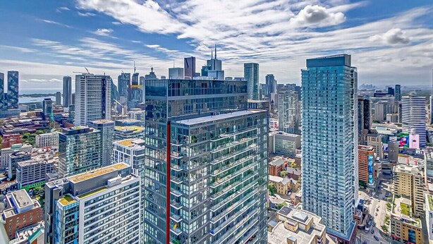 A high-rise urban skyline with modern architecture and a clear sky.