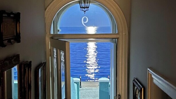 A hallway leading to a balcony with a view of the sea. - Edwardian Beach Villa in Whitehead, Beach Front Period Edwardian Villa (Whitehead)