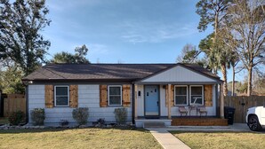 A single-story house with a front porch, a mailbox, and a driveway.