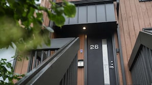 A modern building with a black door marked with the number 26. - Unit 26 - Ski-in/Ski out at Mont-Sainte-Anne for 8 people (Beaupré)