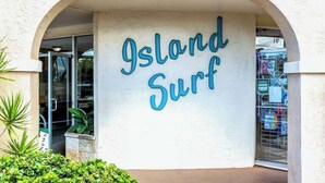 A building entrance with the sign 'Island Surf' and a glass door. - Oceanview 1 bedroom condo, AC, walk to everything in the Kihei triangle (Kihei)