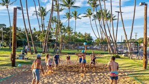 A beach volleyball game on a sandy court with palm trees in the background. - Oceanview 1 bedroom condo, AC, walk to everything in the Kihei triangle (Kihei)