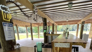 A rustic wooden bar area with a sign reading "CANTINA" and a neon sign for "SPANISH 101."