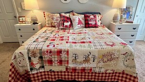 A bedroom with a large bed, two bedside tables, and a nightstand.