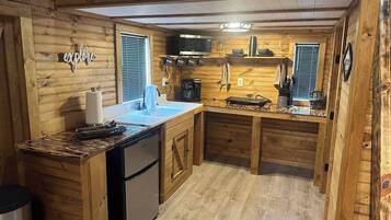 Fridge, microwave, coffee/tea maker, cookware/dishes/utensils