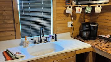 Fridge, microwave, coffee/tea maker, cookware/dishes/utensils