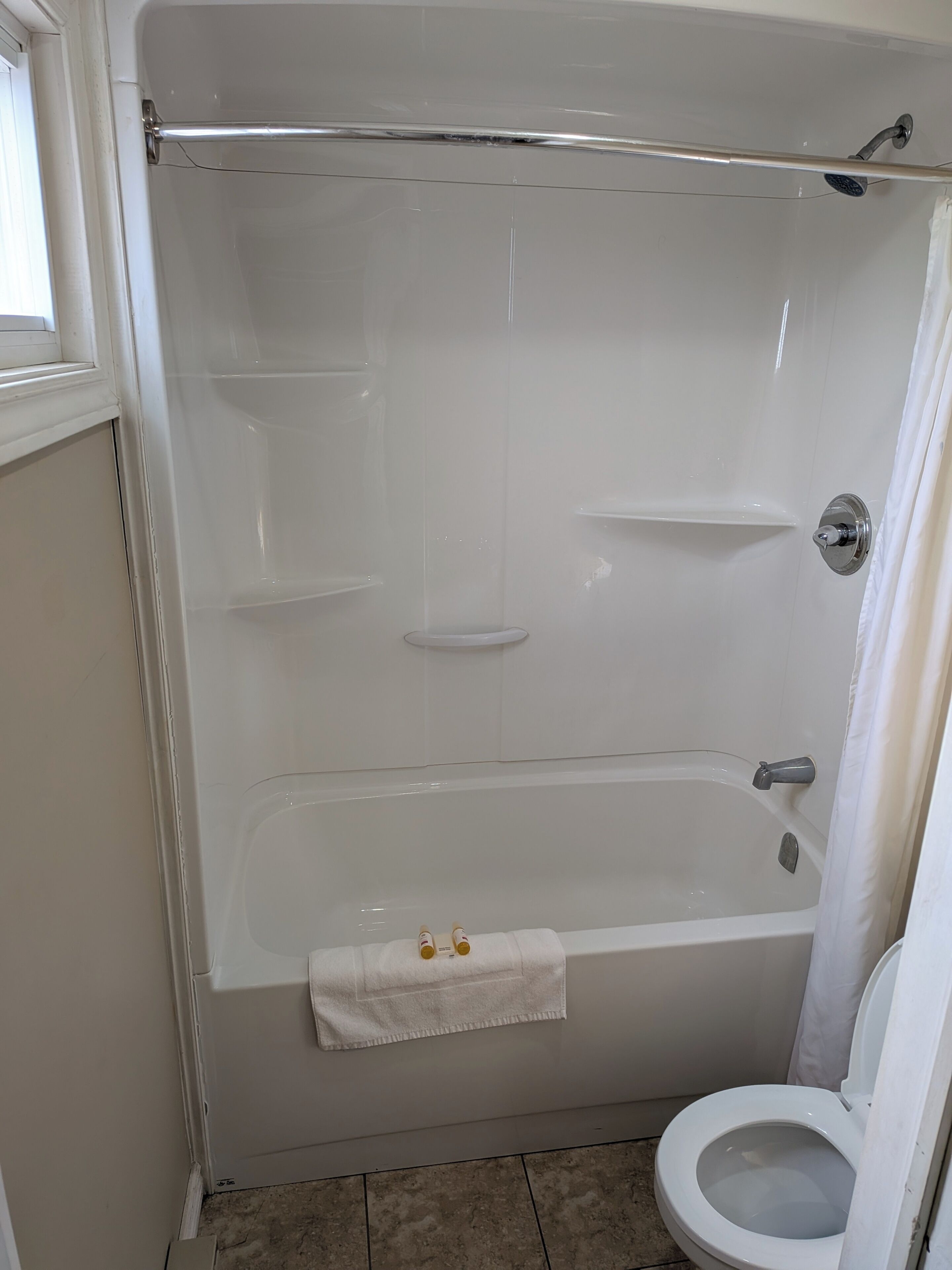 Bathtub, towels, soap, shampoo