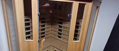 A wooden cabinet with glass doors, featuring multiple shelves and compartments.