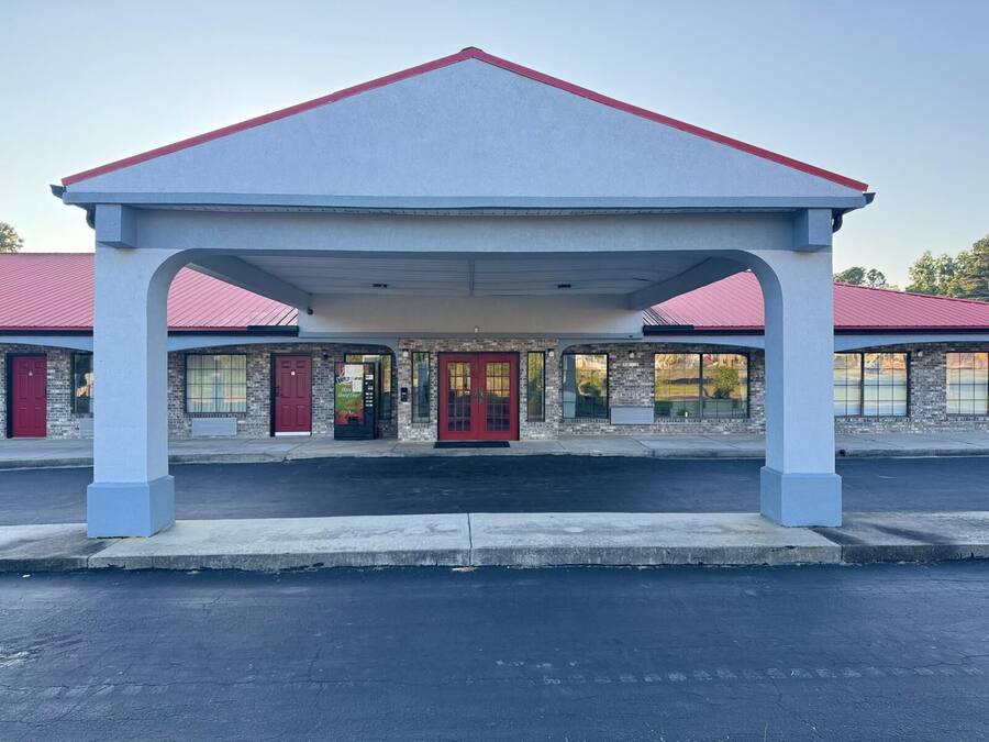 A building with a red roof and a covered entrance area.