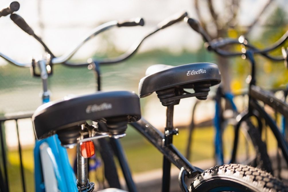 A close-up of a bicycle with a branded seat and handlebars.