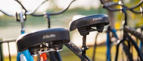 A close-up of a bicycle with a branded seat and handlebars.