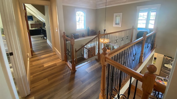A spacious interior with a wooden staircase, a dining area, and a view of the outdoors. - The Orchard at Lovers Lane and Enchanted Forest. Hot Tub, Pets Welcome (Eastsound)