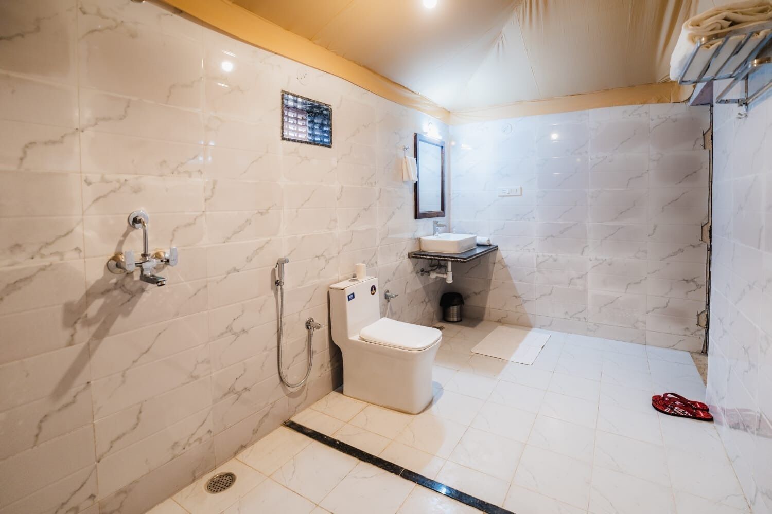 A modern bathroom with a toilet, sink, and shower area.